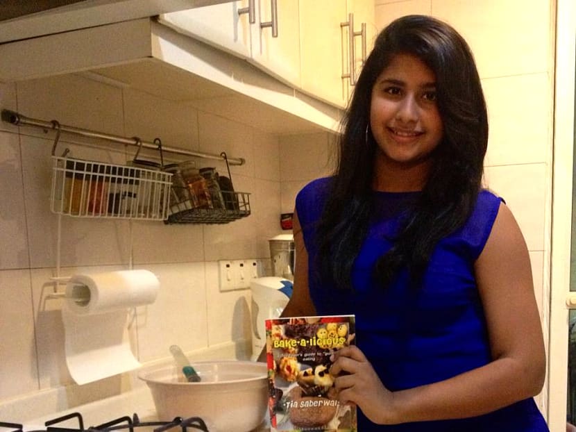 Lavanya Saberwal or 'Tia' as she is often called, posing with her cookbook, Bake-a-licious. Photo: Mohd Azhar Aziz