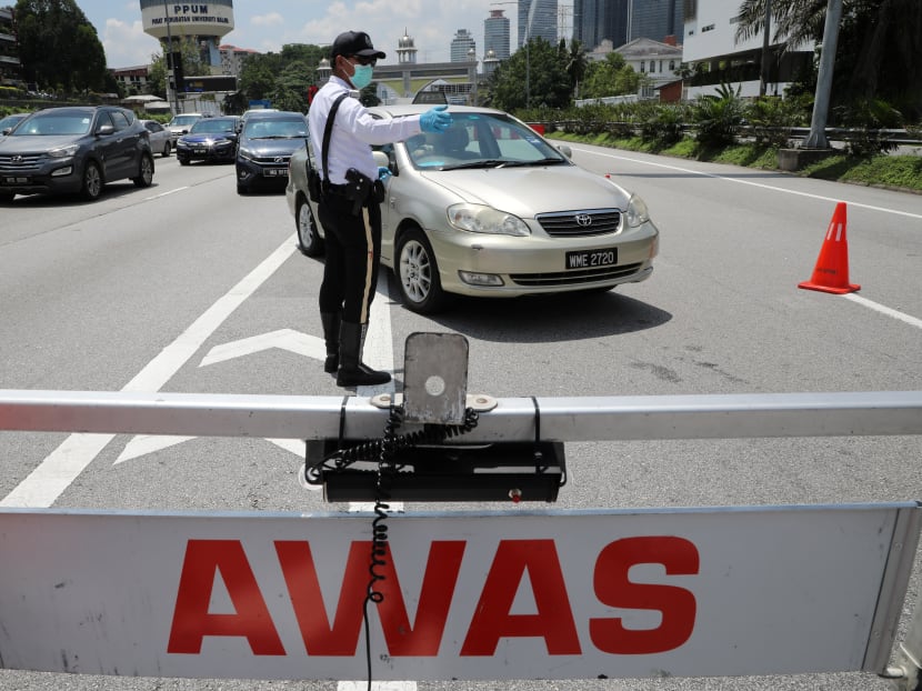 A police officer stands guard at a roadblock during lockdown ahead of the Aidilfitri celebrations in an effort to prevent a large-scale transmission of the coronavirus disease, in Petaling Jaya, Malaysia on Monday, May 10, 2021