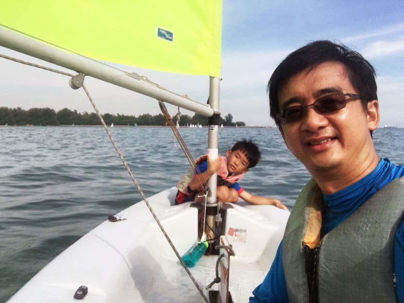 The author, seen here sailing with his son, says that his son's experience with sailing as a CCA shows the need to de-emphasise the importance of winning and teaching kids how to deal to failure. Photo: Desmond Wai