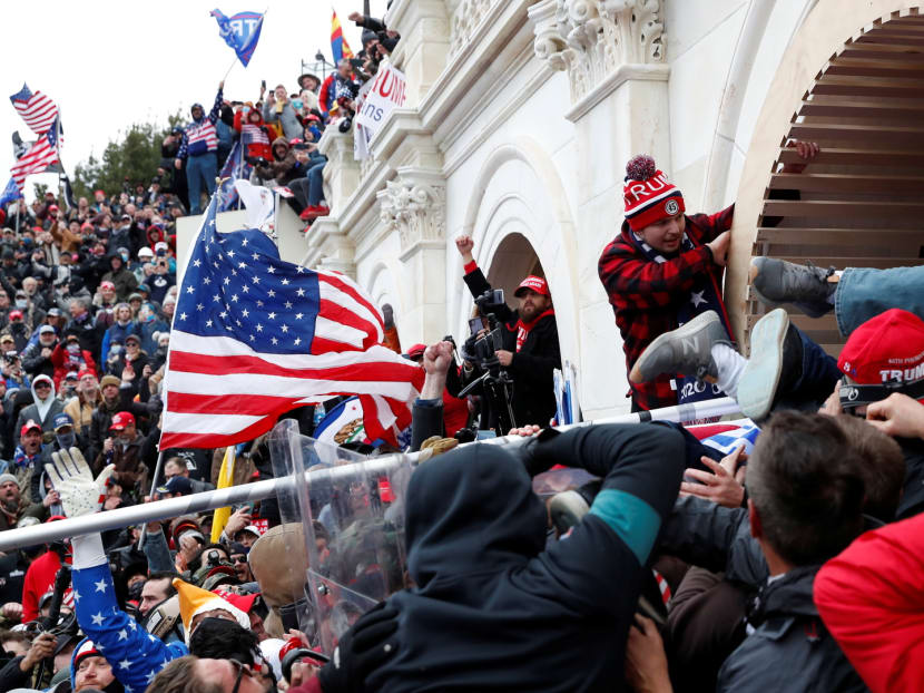 Pro-Trump protesters storm into the US Capitol during clashes with police, during a rally to contest the certification of the 2020 US presidential election results by the US Congress in Washington on Jan 6, 2021.