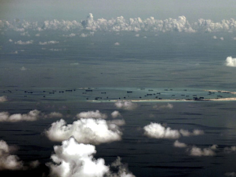 An aerial file photo taken though a glass window of a Philippine military plane shows the alleged on-going land reclamation by China on Mischief Reef in the Spratly Islands in the South China Sea, west of Palawan, Philippines May 11, 2015. Photo: Reuters