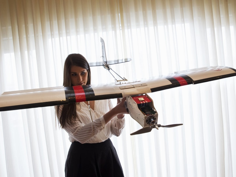 Ms Lia Reich, director of marketing with PrecisionHawk, holds up their agricultural and insurance drone, the PrecisionHawk Lancaster, after an event with the Small Unmanned Aerial Vehicles (UAV) Coalition, at the National Press Club in Washington. Photo: AP