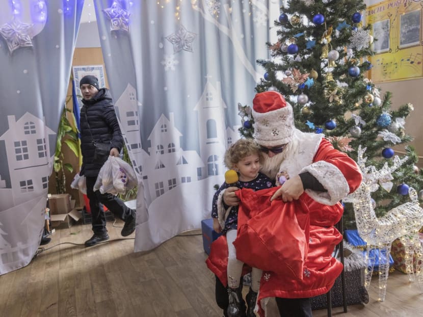 Parents and children line up to take photos with Mr Yevhen Vorobyov, who dressed as Saint Nicholas for a celebration in Mykolaiv, Ukraine, on Dec 19, 2022. Parents and children line up to take photos with Mr Yevhen Vorobyov, who dressed as Saint Nicholas for a celebration in Mykolaiv, Ukraine, on Dec 19, 2022.