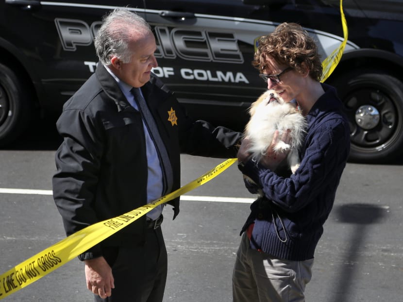 Photo of the day: Burlingame police chief Eric Wollman hands over Kimba to his owner following an active shooter situation at Youtube headquarters in San Bruno, California