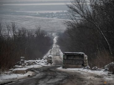 A car rides on an empty road near a frontline, amid Russia's attack on Ukraine, in Donetsk region, Ukraine January 29, 2023. REUTERS/Viacheslav Ratynskyi 