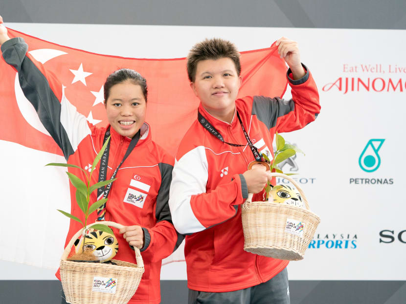 Singapore's Danielle Moi and Chew Zi Ling celebrate their gold and bronze medals in the women's 200m S14 freestyle event at the 2017 Asean Para Games. Photo: Sport Singapore