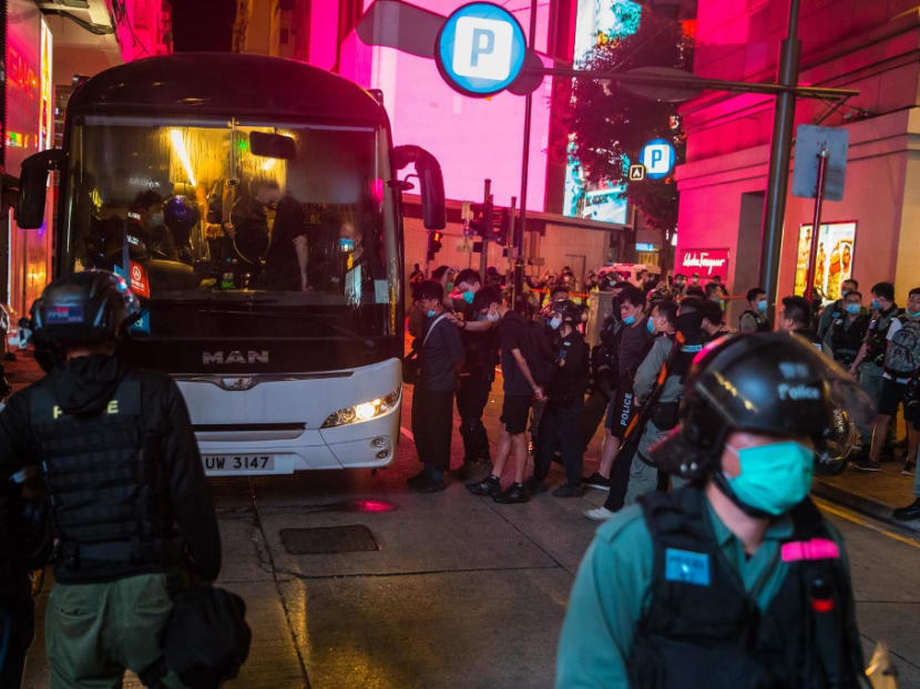 Police detain people on a bus after they cleared protesters taking part in a rally against a new national security law in Hong Kong on July 1, 2020, on the 23rd anniversary of the city's handover from Britain to China.
