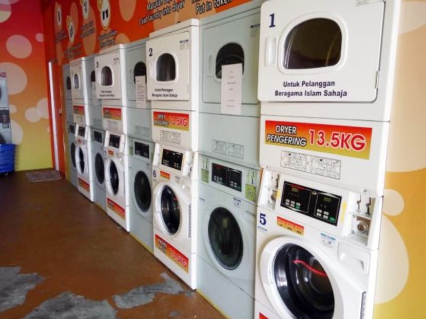 The interior of the self-service laundromat in Muar, Johor which used to bar non-Muslim customers. Another shop in Johor has attracted attention with its “Malays only” business policy, two months after the state ruler’s stinging rebuke of the laundromat’s practice. Photo: Eileen Ng/TODAY