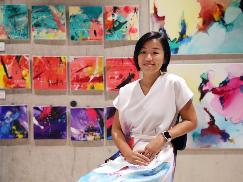 The writer, seen here with her paintings at Design Orchard, on Nov 24, 2021. 
