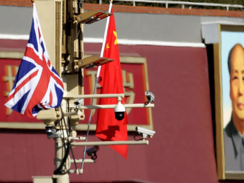 A Union flag and a Chinese flag are placed at a pole with security cameras in front of a portrait of late Chinese Chairman Mao Zedong at the Tiananmen gate during a visit by British Prime Minister Theresa May to China, in Beijing, on Jan 31, 2018.