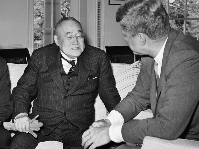 President John F Kennedy is an attentive listener as he visits with Shigeru Yoshida, former Prime Minister of Japan, and Japanese Ambassador Koichiro Asakai, left, in his White House office in Washington, May 3, 1962. Photo: AP