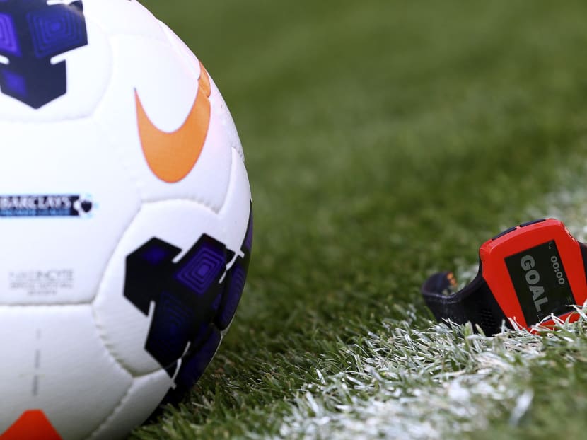 A ball and the referee's watch are seen during the Goal Decision System (GDS) presentation at the Emirates Stadium in London August 8, 2013. The English Premier League will become the first domestic competition to adopt the camera-based technology when it kicks off on August 17. Photo: Reuters