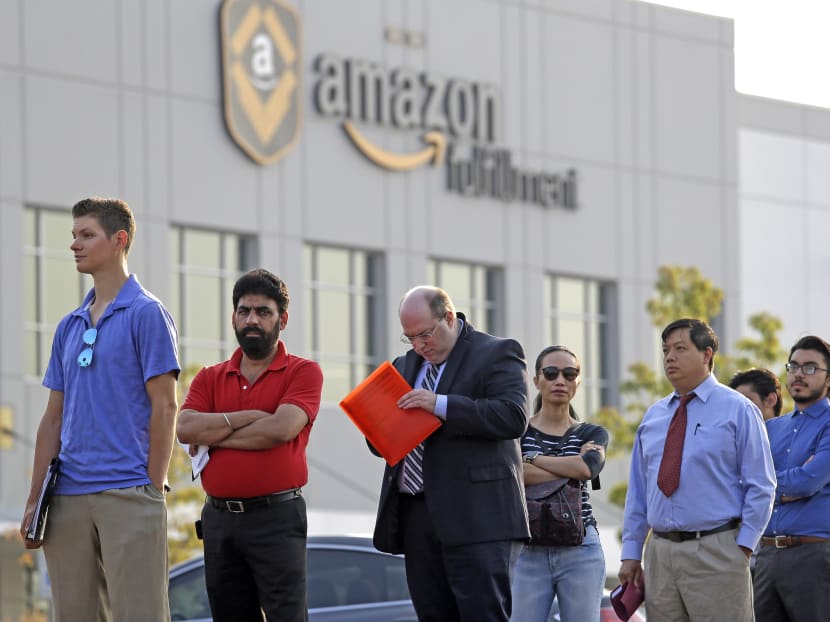 Applicants wait in line to enter a job fair, Wednesday, Aug. 2, 2017, at an Amazon fulfillment center, in Kent, Wash. Amazon plans to make thousands of job offers on the spot at nearly a dozen U.S. warehouses during the recruiting event. Photo: AP