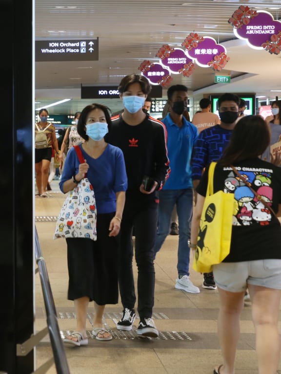 A crowd of people at the underpass connecting Orchard MRT and Tangs Plaza on Feb 13, 2022.