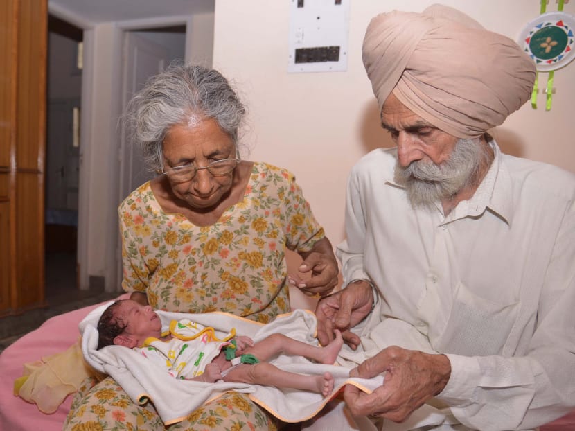 Indian parents Mohinder Singh Gill (left), 79, and Daljinder Kaur, 70, pose for a photograph as they hold their newborn baby boy Arman at their home in Amritsar on May 11, 2016. Photo: AFP