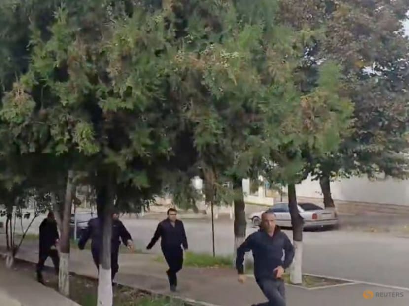 People run as gunfire and explosions are heard in Stepanakert, called Khankendi by Azerbaijan, in the Nagorno-Karabakh region, September 19, 2023, in this screengrab obtained from a handout video.  Artsakh Public TV/Handout via REUTERS