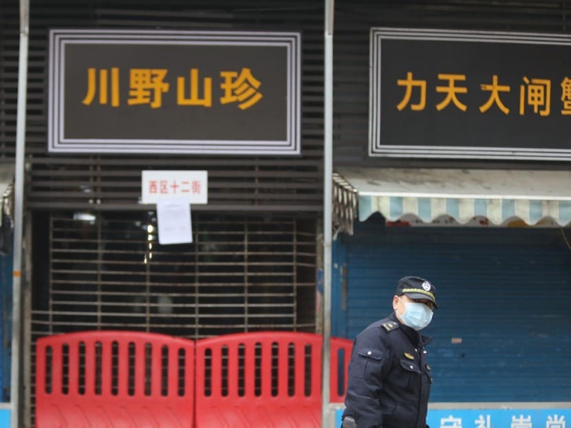 A security patrol outside the Wuhan Huanan Seafood Wholesale Market, which has been identified as the site of the outbreak.