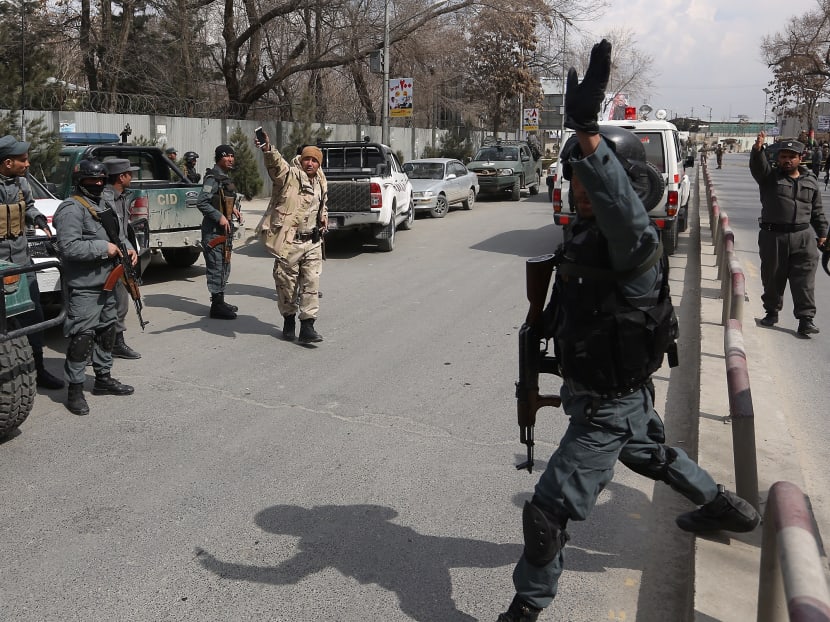 Security forces inspect the site of attack on a military hospital in Kabul, Afghanistan. Photo: AP
