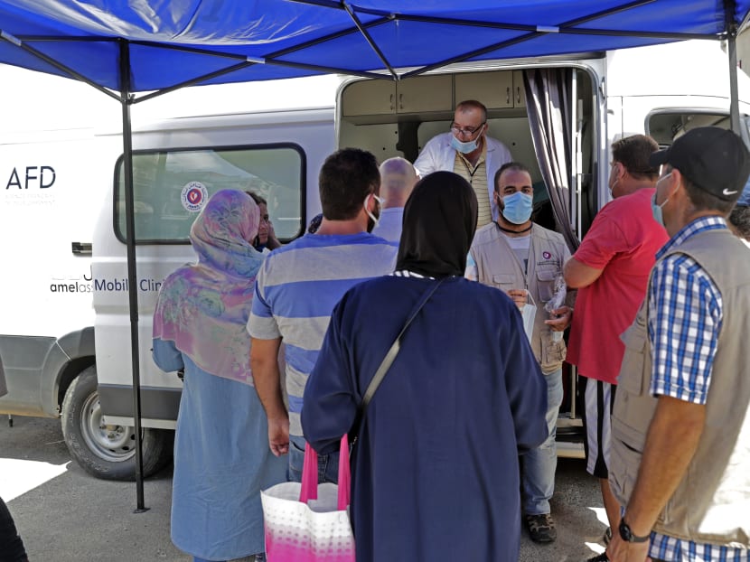 Medics working at a mobile clinic held jointly by Lebanese NGO Amel Association International and Medecins du Monde (MDM) provide medical care on Aug 11, 2020 to the residents of Beirut's badly-damaged Karantina district following the earth-shaking explosion which killed more than 170 people and wounded more than 6,000 in the Lebanese capital on Aug 4.