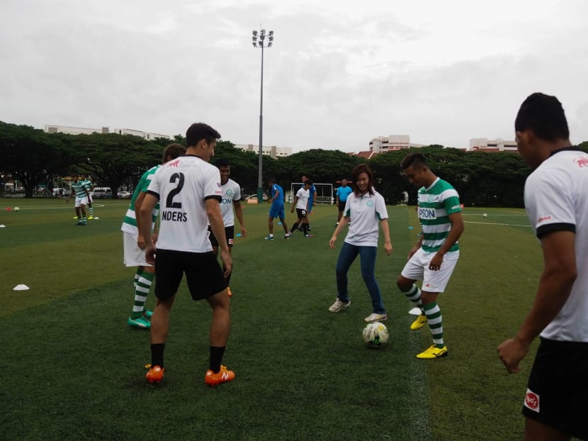 Geylang International advisor Tin Pei Ling (centre) playing football with some of the club's players. PHOTO COURTESY: S.LEAGUE