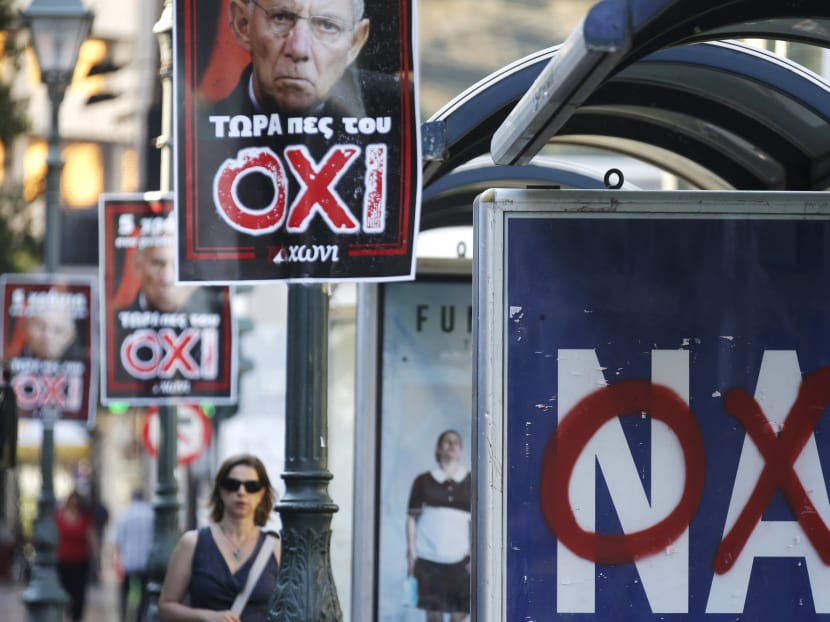 A referendum campaign poster that reads 'Yes (Nai)' is seen on a bus stop with a graffiti that reads 'No (Oxi)' on it in Athens, Greece, July 3, 2015. Photo: Reuters