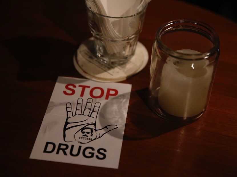 A anti-drug sticker found on the tables of Escobar bar in China Square Central on Feb 9. The stickers were put up by the management. Photo: Najeer Yusof/TODAY