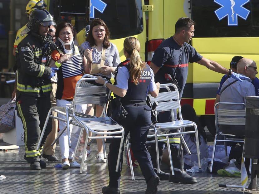 Injured people being treated in Barcelona, Spain yesterday after a white van jumped the pavement in the historic Las Ramblas district and crashed into a summertime crowd of residents and tourists, causing multiple deaths and injuries. Photo: AP
