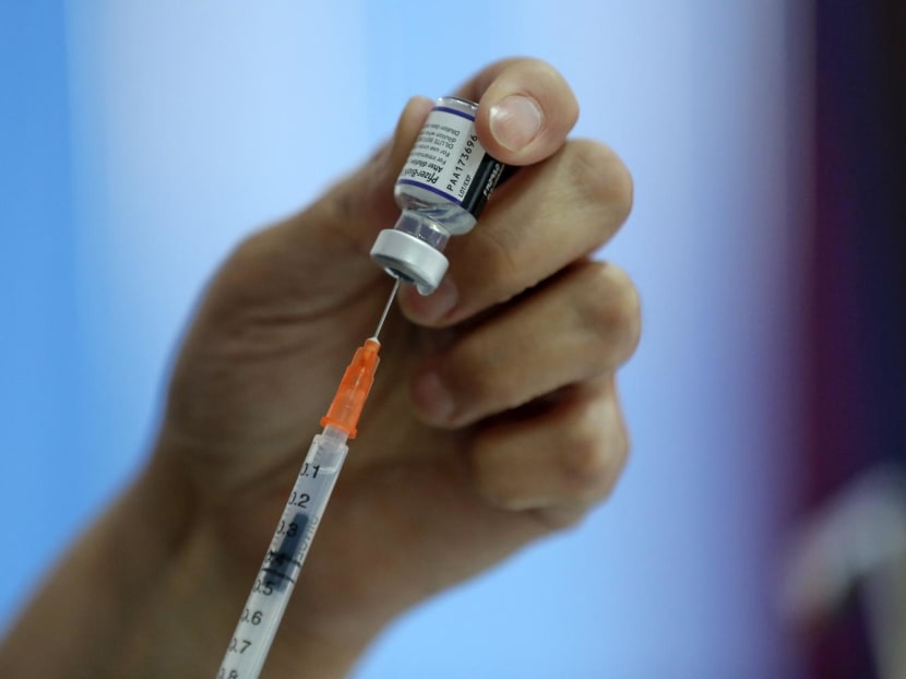 A health worker preparing a dose of the Pfizer-BioNTech vaccine. A health worker preparing a dose of the Pfizer-BioNTech vaccine.