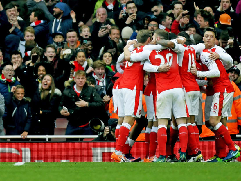 Arsenal players celebrating a goal against Tottenham Hotspur during a Premier League match on Nov 6. Unbeaten away from home since March, with just two defeats on their travels in 2016, Arsenal’s players are brimming with confidence and have nothing to fear from this trip to Old Trafford. Photo: Reuters
