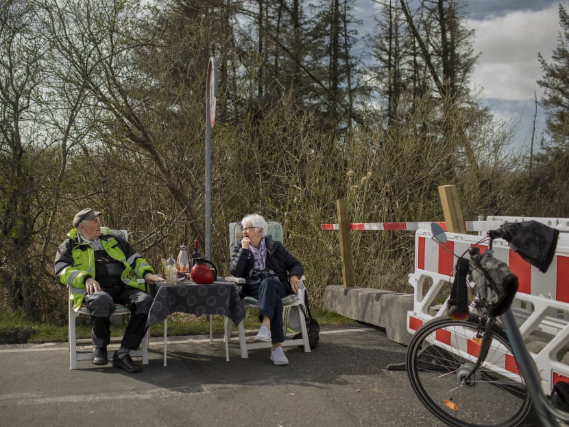 Mr Karsten Tüchsen Hansen and Ms Inga Rasmussen, keep their love alive despite the closed border between their countries, as they meet at the Mollehusvej Border Crossing, between Denmark and Germany, on April 16, 2020.