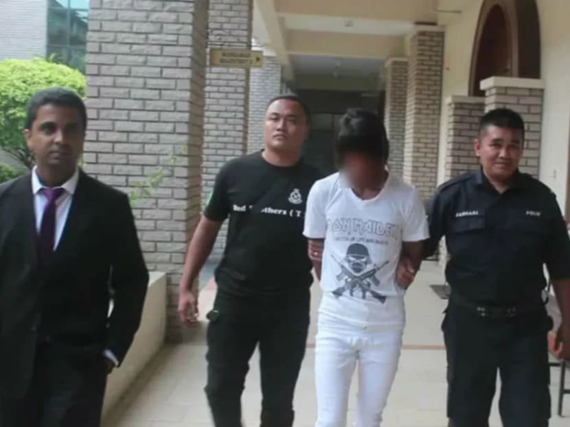 Policemen escort Mohd Ayub Darman (centre) at the Sandakan Sessions Court where he was sentenced to 40 years in jail and 24 strokes of the cane for raping his employer’s daughter.