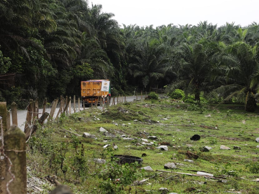 A truck travels along an empty field, the site for the proposed HSR station for Seremban in Labu, a quiet hamlet peppered with Malay villages and palm oil plantations.