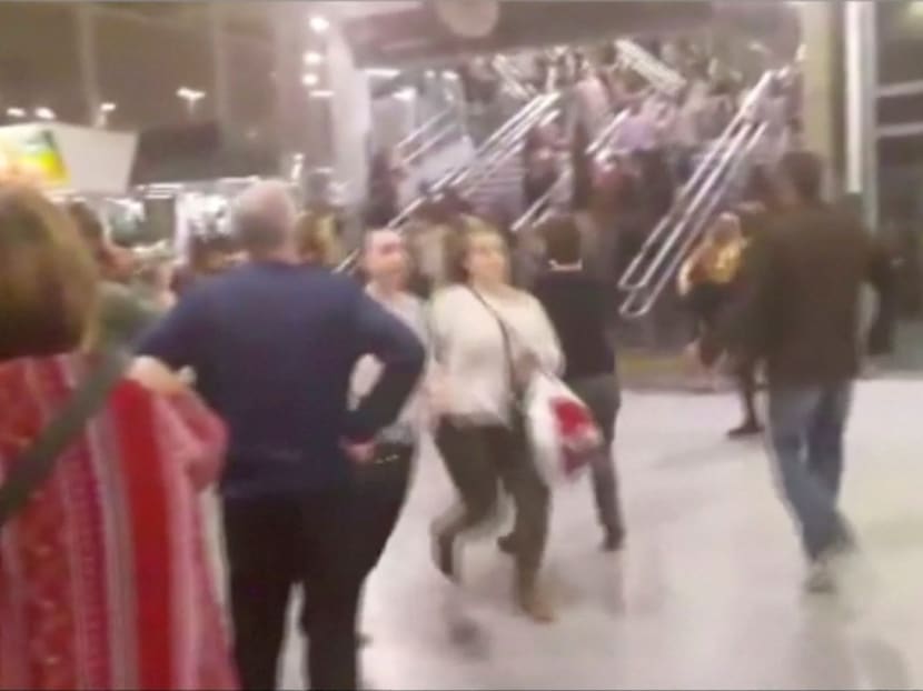 People running down stairs as they attempt to exit the Manchester Arena after a blast, where U.S. singer Ariana Grande had been performing, in Manchester, Britain in this still image taken from video May 22, 2017. Photo via Reuters