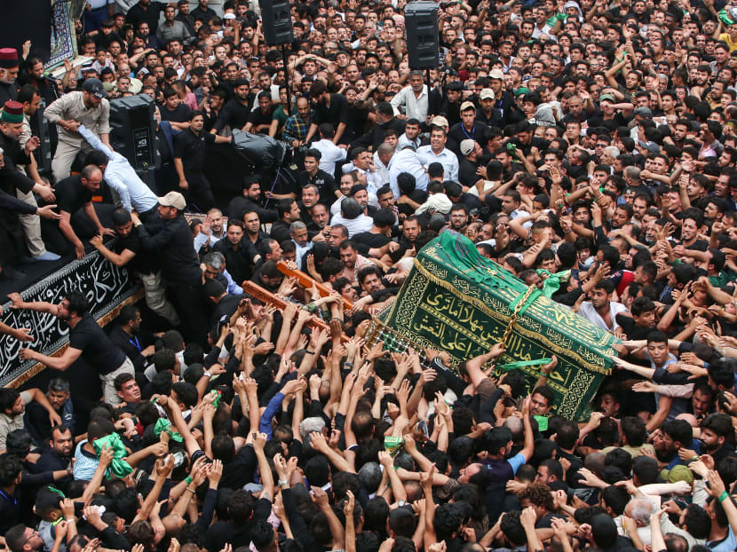 Iraqi Shiite Muslim worshipers carry the symbolic coffin of Imam Musa al-Kadhim during the funeral processions on the anniversary of his death by his shrine in Baghdad’s northern district of Kadhimiya. Photo: AFP