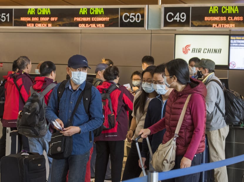 Chinese citizens wear face masks to protect against the spread of the Coronavirus as they check in to their Air China flight to Beijing, at Los Angeles International Airport, California, on Feb 2, 2020.