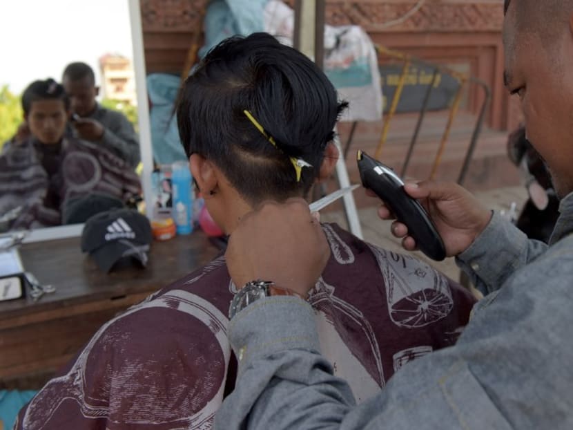 A file photograph of a man in Cambodia's Phnom Penh getting his haircut. Photo: AFP