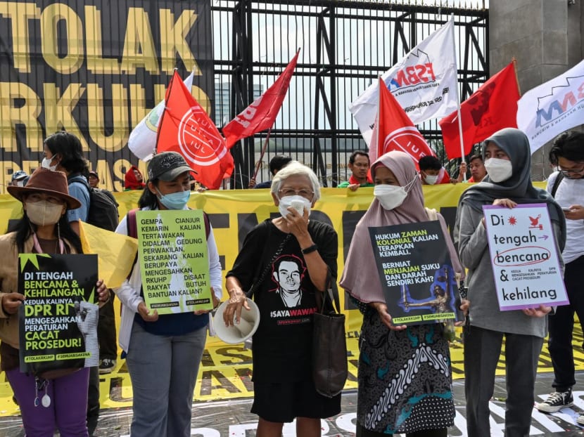Activists holding a protest against the new criminal code outside the parliament building in Jakarta on Monday (Dec 5).
