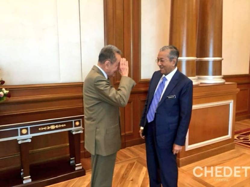 The tycoon salutes the Dr Mahathir at his office in Perdana Putra.