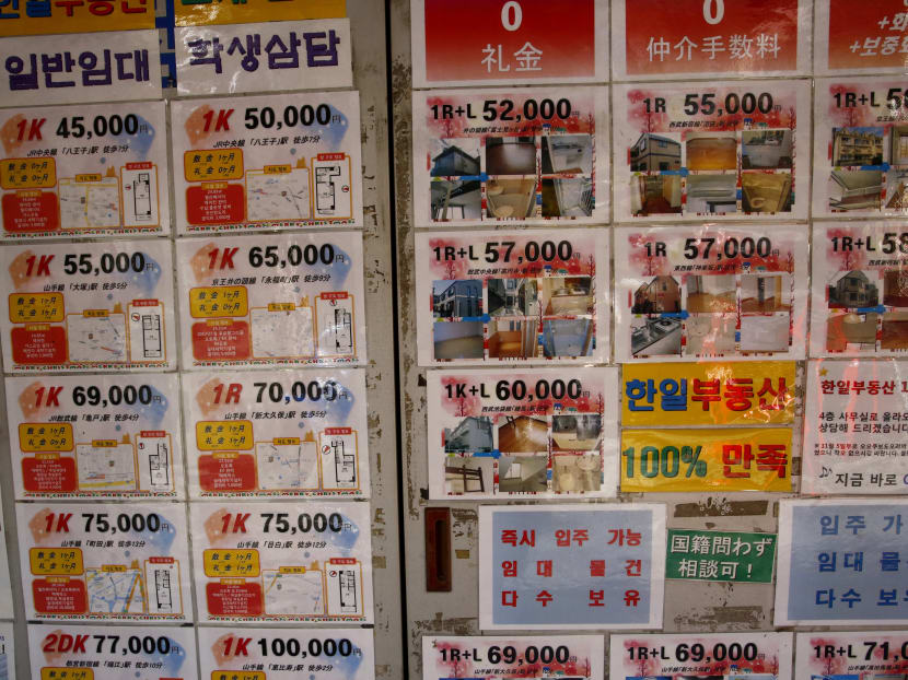 Real estate agent's advertisements offering apartment rooms, written in Korean, are displayed in front of the agent in Tokyo's Korean district. Photo: AP