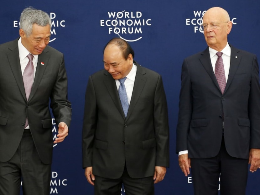Prime Minister Lee Hsien Loong (left), Vietnam's prime minister Nguyen Xuan Phuc (centre) and Mr Klaus Schwab (right), founder and executive chairman of the World Economic Forum, during a meeting in Vietnam that focused on the Association of Southeast Asian Nations in 2018.