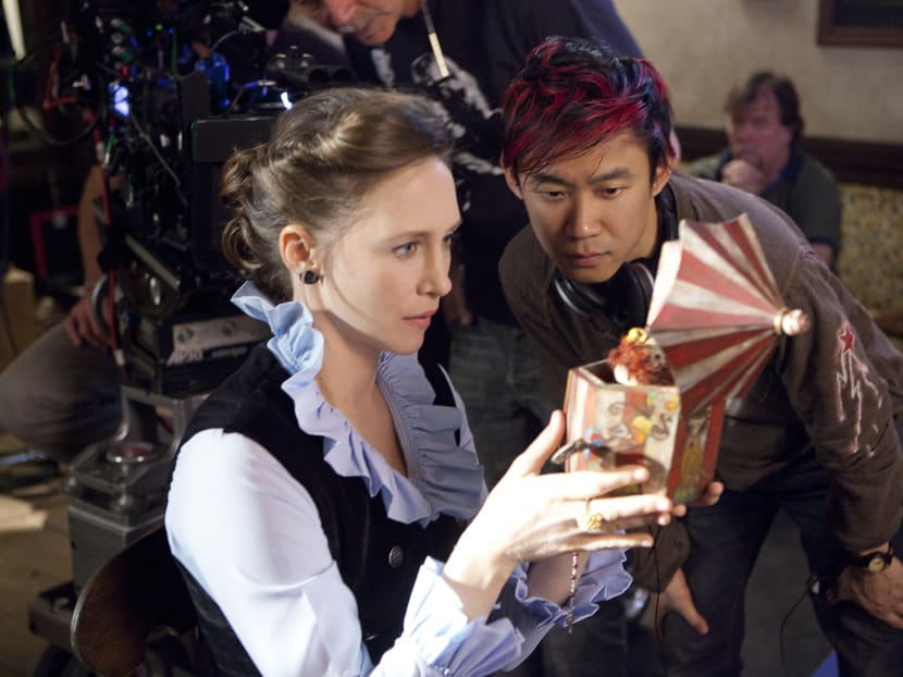 Director James Wan directs Vera Farmiga on the set of The Conjuring.