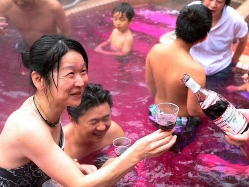 Super soaking time: Guests at the spa enjoy a drinking - and soaking in - red wine. Photo: ELLE.sg