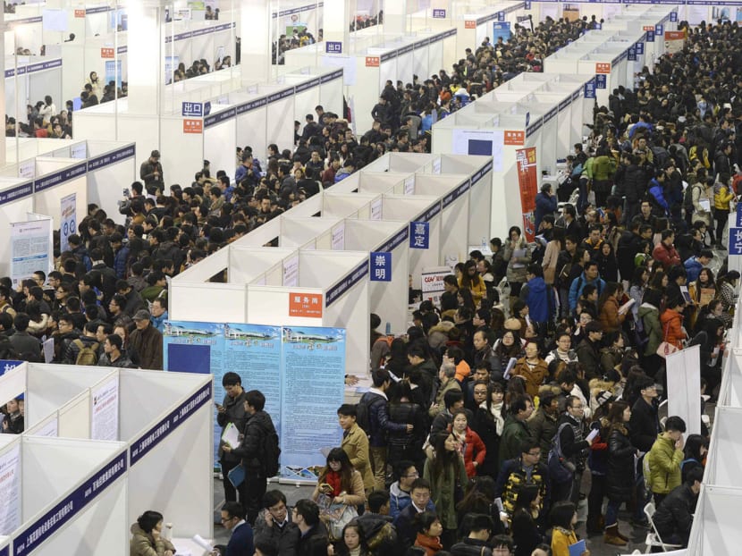 People at a job fair in China. Many migrants with low skills stand little chance of settling in the large cities, which are curbing their populations to tackle congestion, pollution and limited resources. Photo: Reuters