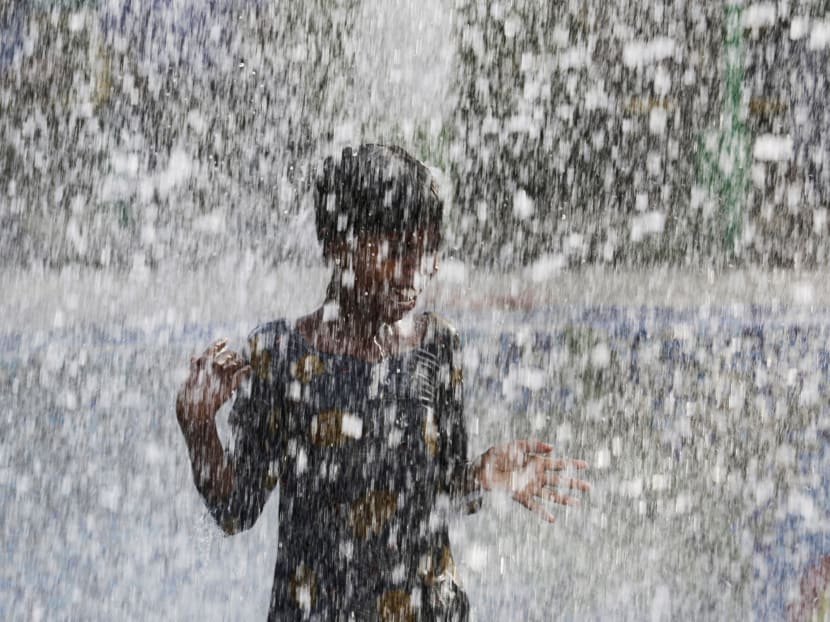 An Indian child bathes under a public  fountain on a hot afternoon in Lucknow, India, Monday, May 16, 2016.  Photo: AP