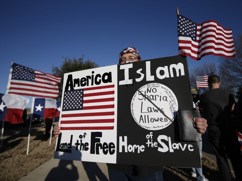 A protestor walks along the sidewalk outside the Curtis Culwell Centre where a Muslim conference against terror and hate was scheduled, in Garland, Texas on Jan 17, 2015. Photo: AP