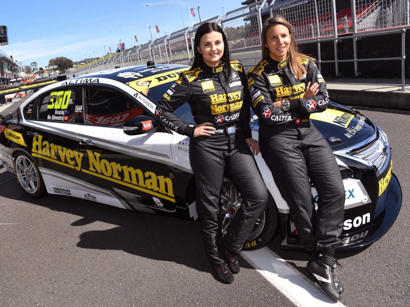 Female drivers: Swiss driving ace Simona de Silvestro (right) and co-driver Australian Renee Gracie with their race car as they prepare for the Bathurst 1000 race. Photo: AFP