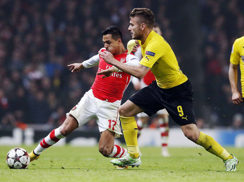Alexis Sanchez (left) proved himself an inspired signing for Arsenal, curling in their second goal. Photo: AP