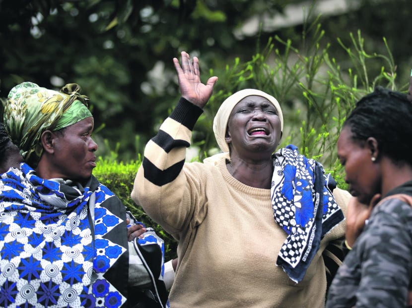 Ms Mary Italo grieving at the Nairobi mortuary yesterday with relatives for her son, Thomas, who was killed in the Westgate mall attack. Photo: AP