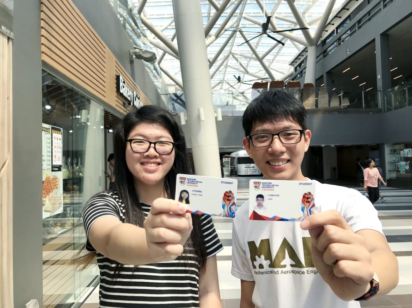 Year 3 students Leong Li Zhen (left) and Justin Wongso (right) holding up the NTU Smart Pass card. Photo: Toh Ee Ming/TODAY