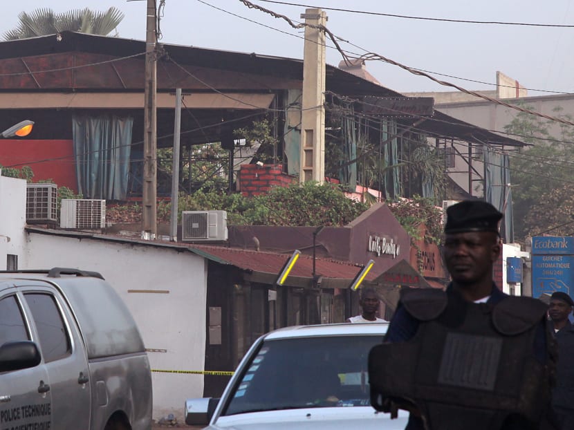 The nightclub, rear, that was attacked by gunmen as Mali police, centre, provide security in Bamako, Mali, on Saturday, March 7, 2015. Photo: AP